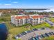 Aerial view of condo building showcasing its waterfront location and landscaping at 125 Mariner Dr # 125, Tarpon Springs, FL 34689