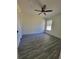 Spacious bedroom with wood-look flooring, ceiling fan, and ample natural light at 1302 E Annie St, Tampa, FL 33612