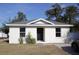 Newly constructed home with a modern exterior and landscaped yard at 1302 E Annie St, Tampa, FL 33612