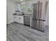 Modern kitchen with stainless steel appliances and gray vinyl flooring at 1302 E Annie St, Tampa, FL 33612