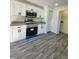 Modern kitchen with white cabinets, granite countertops, and stainless steel appliances at 1302 E Annie St, Tampa, FL 33612
