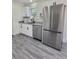 Modern kitchen with stainless steel appliances and gray vinyl flooring at 1302 E Annie St, Tampa, FL 33612