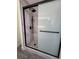 Modern shower with frameless glass door and marble-look tile at 1302 E Annie St, Tampa, FL 33612
