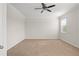 Large bedroom with plush carpeting and ceiling fan at 13557 Bee Tree Ct, Hudson, FL 34669