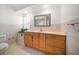 Well-lit bathroom with wooden vanity, drawers, and a large mirror at 1388 S Hercules Ave, Clearwater, FL 33764