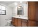 Bathroom with a wooden vanity, drawers, framed mirror, and tiled walls at 1388 S Hercules Ave, Clearwater, FL 33764