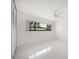 Minimalist bedroom featuring a large window, ceiling fan, and built-in closet at 1388 S Hercules Ave, Clearwater, FL 33764