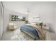 Cozy bedroom with a ceiling fan, area rug, large window, and neutral color palette at 1388 S Hercules Ave, Clearwater, FL 33764