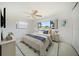Bright bedroom with a ceiling fan, a patterned rug, and a large window providing lots of natural light at 1388 S Hercules Ave, Clearwater, FL 33764