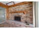 Close-up of the fireplace with its tile base and rustic mantel, adding warmth to the space at 1388 S Hercules Ave, Clearwater, FL 33764