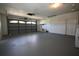 Spacious two-car garage with painted floor and storage shelves at 1388 S Hercules Ave, Clearwater, FL 33764