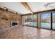 Spacious living room with a fireplace, tile flooring, and a view of the swimming pool at 1388 S Hercules Ave, Clearwater, FL 33764