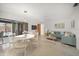 Bright living room with dining area, stylish furniture, and sliding glass doors to the screened pool at 1388 S Hercules Ave, Clearwater, FL 33764