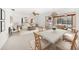 Bright living room with dining area, stylish furniture, and sliding glass doors to the screened pool at 1388 S Hercules Ave, Clearwater, FL 33764