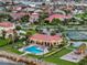Beautiful aerial shot of community pool, playground, tennis courts and lush landscaping by the bay at 1414 Alhambra Dr, Apollo Beach, FL 33572
