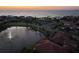 Aerial view of a lake with fountain, homes, and access to the water at 1414 Alhambra Dr, Apollo Beach, FL 33572