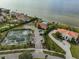 Scenic aerial view of bayfront homes, tennis courts, pool, playground, and landscaping at 1414 Alhambra Dr, Apollo Beach, FL 33572