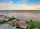 Stunning waterfront view featuring a community pool, playground and picturesque sunset over the bay at 1414 Alhambra Dr, Apollo Beach, FL 33572
