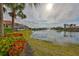 Backyard view showing a pond and tropical landscape, creating a serene outdoor setting at 1414 Alhambra Dr, Apollo Beach, FL 33572