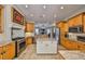 Kitchen with granite countertops, tile floor, stainless appliances, and center island at 1414 Alhambra Dr, Apollo Beach, FL 33572