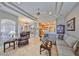 Open-concept living room featuring a neutral color palette, tray ceilings and tile floors, flowing to kitchen and dining areas at 1414 Alhambra Dr, Apollo Beach, FL 33572