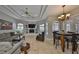Open living room with tile flooring, ceiling fan, fireplace, and casual dining area at 1414 Alhambra Dr, Apollo Beach, FL 33572