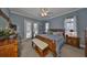Cozy main bedroom features a king bed, bench, and access to a private patio at 1414 Alhambra Dr, Apollo Beach, FL 33572