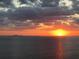 Beautiful sunset view over the ocean with dramatic clouds and the city skyline in the distance at 1414 Alhambra Dr, Apollo Beach, FL 33572