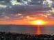 Stunning sunset over the water, complemented by a cityscape and luxurious waterfront houses at 1414 Alhambra Dr, Apollo Beach, FL 33572