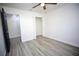 Bright bedroom with wood-look floors, ceiling fan, and spacious closet at 1502 Cherrywood Ave, Tampa, FL 33613