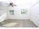 Light-filled bedroom featuring wood-look floors, a ceiling fan, and lake views at 1502 Cherrywood Ave, Tampa, FL 33613