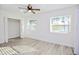 Bedroom with wood-look floors, two windows, and a closet at 1502 Cherrywood Ave, Tampa, FL 33613