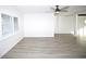 Living room with wood-look floors and plantation shutters at 1502 Cherrywood Ave, Tampa, FL 33613