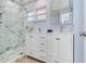 Elegant bathroom with a marble shower and double vanity at 17410 1St E St, Redington Shores, FL 33708