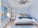 Spacious bedroom with water views and a ceiling fan at 17410 1St E St, Redington Shores, FL 33708