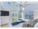 Bright bedroom with water views, large windows, and a walkout balcony at 17410 1St E St, Redington Shores, FL 33708