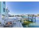 Boat dock with fire pit and seating area, offering waterfront living at 17410 1St E St, Redington Shores, FL 33708