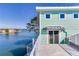 Charming balcony with water views and a teal colored building at 17410 1St E St, Redington Shores, FL 33708
