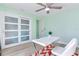 Bright home office features a desk, chair, and sliding doors at 17410 1St E St, Redington Shores, FL 33708