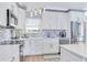 White cabinets, stainless steel appliances, and mosaic backsplash at 17410 1St E St, Redington Shores, FL 33708