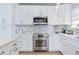 Modern kitchen with stainless steel appliances and white cabinets at 17410 1St E St, Redington Shores, FL 33708