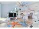 Spacious living area with kitchen, fireplace, and stairs at 17410 1St E St, Redington Shores, FL 33708