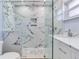 Large walk-in shower with marble tile and glass enclosure at 17410 1St E St, Redington Shores, FL 33708