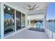 Private waterfront deck with sliding glass doors and ceiling fan at 17410 1St E St, Redington Shores, FL 33708