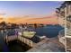 Sunset view over the water with a boat on a private dock at 17410 1St E St, Redington Shores, FL 33708