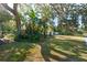 Landscaped front yard with mature trees and lush foliage at 1901 Oakdale S Ln, Clearwater, FL 33764