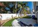 Landscaped backyard with patio, artificial turf and palm trees at 1919 Shore Acres Ne Blvd, St Petersburg, FL 33703