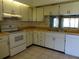 Bright kitchen with white cabinets, wood countertops, and appliances at 2700 Nebraska Ave # 4-101, Palm Harbor, FL 34684