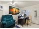 Home office with a large TV, desk, and comfortable armchair at 3310 70Th N Ave, St Petersburg, FL 33702