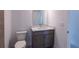 Modern bathroom with gray vanity, quartz countertop, and a toilet at 475 Winwood Ct, Port Charlotte, FL 33954